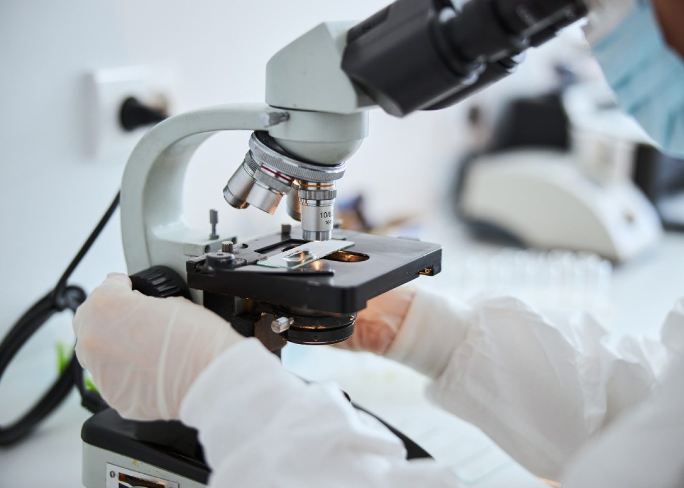 lab-technician-examining-cells-under-the-microscop-2022-03-09-03-12-48-utc